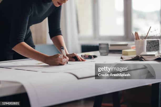 anonymous architect working on her project - close up of blueprints stock pictures, royalty-free photos & images