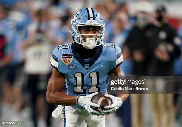 Josh Downs of the North Carolina Tar Heels catches his second touchdown pass against the Texas A&M Aggies in the fourth quarter of the Capital One...