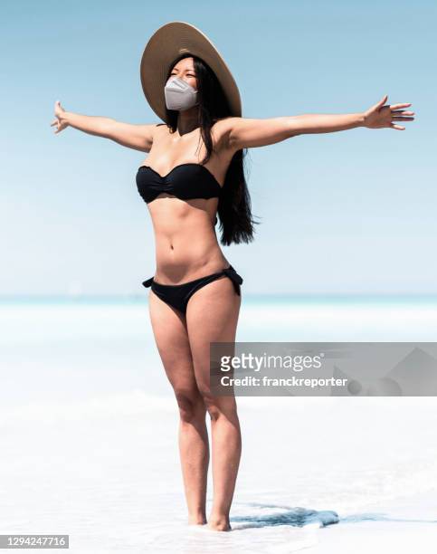 chinese sensual woman on the beach walking with face mask - air respirator mask stock pictures, royalty-free photos & images