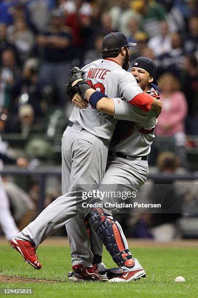 Jason Motte and Yadier Molina of the St. Louis Cardinals celebrate after they won 12-6 against the Milwaukee Brewers during Game Six of the National...