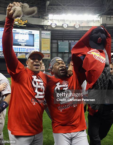 Octavio Dotel and Arthur Rhodes of the St. Louis Cardinals celebrate with a rally squirrel after they won2-6 against the Milwaukee Brewers during...