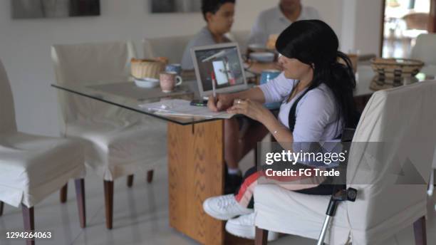 dwarf woman on a video call while studying at home - dwarf stock pictures, royalty-free photos & images