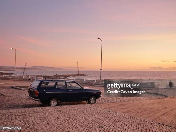 vintage station wagon car in parking lot along coast - estate car stock pictures, royalty-free photos & images