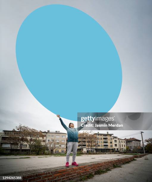 young male holding big circle banner in city - big sale stock pictures, royalty-free photos & images