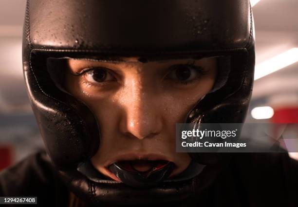 sweaty female fighter looking at camera - headwear ストックフォトと画像