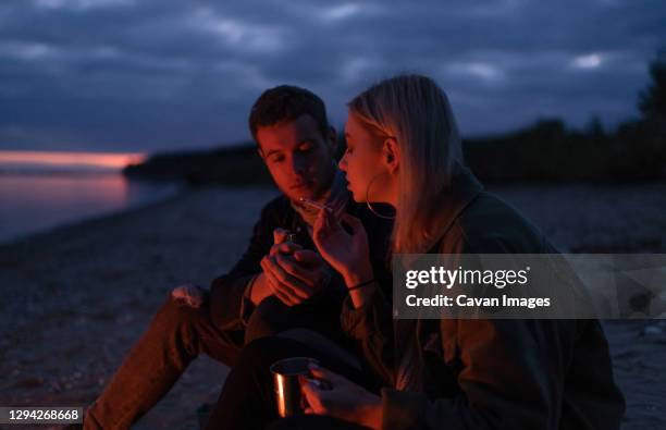 hipsters smoking cannabis at night - human joint stock-fotos und bilder