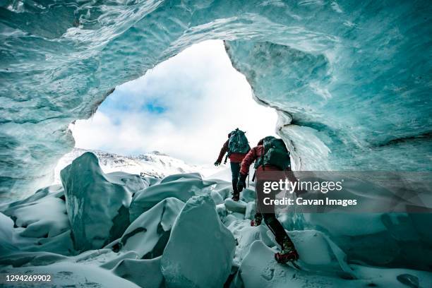 mountaineers exploring inside of glaciers in jasper - jasper canada stock pictures, royalty-free photos & images