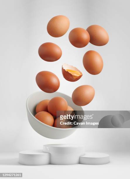 fresh eggs flying over a winning podium - food flying stock-fotos und bilder