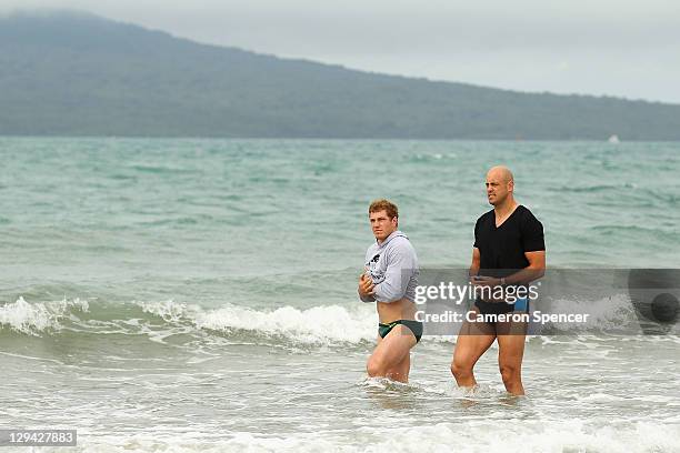 David Pocock and Nathan Sharpe of the Wallabies look on during an Australia IRB Rugby World Cup 2011 recovery session at Takapuna Beach on October...