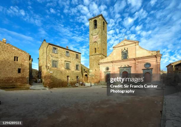 medieval church and bell tower in old town market square of civita di bagnoregio in lazio, italy - provinsen viterbo bildbanksfoton och bilder