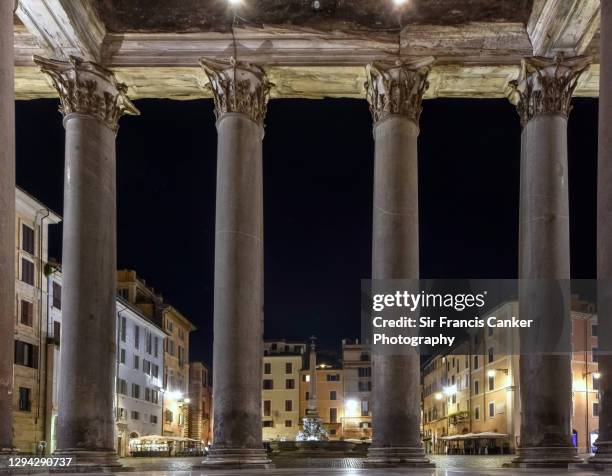 close up image of the rome pantheon corinthian columns seen from the opposite side and illuminated at night in rome, lazio, italy - views of rome the eternal city stock pictures, royalty-free photos & images