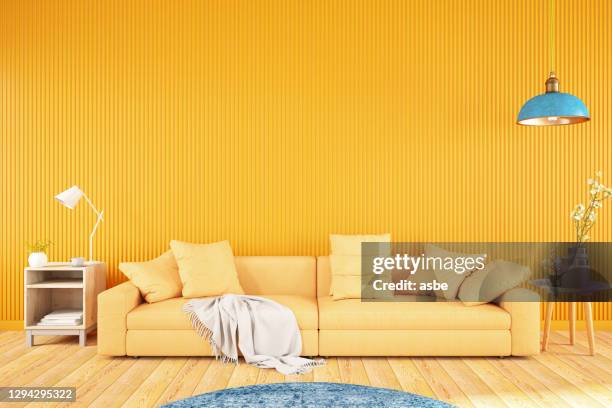 yellow living room with sofa - bright orange color stock pictures, royalty-free photos & images