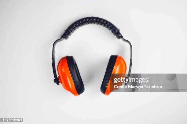 large black-orange headphones on a gray background. - anthropomorphic face stock pictures, royalty-free photos & images