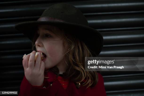 girl eating sandwich outside in winter. - sandwich kent stock pictures, royalty-free photos & images