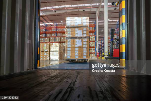 workers loading truck with forklift. - dump truck stock-fotos und bilder