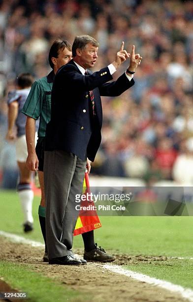 Alex Ferguson of Manchester United shouts some orders to his players in a match between West Ham United v Manchester United played at Upton Park,...