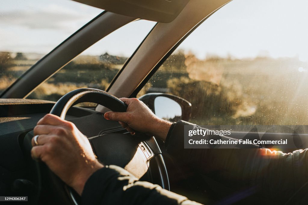 Hand holding steering wheel in a Car