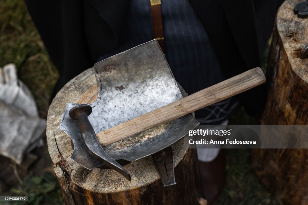 Reconstruction of ancient crafts. The work of a blacksmith. Detail of the metal armor of a real warrior.