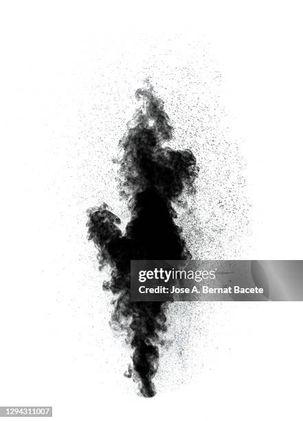 explosion by an impact of a cloud of particles of powder and smoke of black color on a white background. - black smoke stock-fotos und bilder