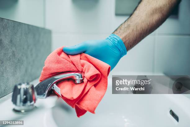 hands of a janitor cleaning the bathroom - serviços de limpeza imagens e fotografias de stock