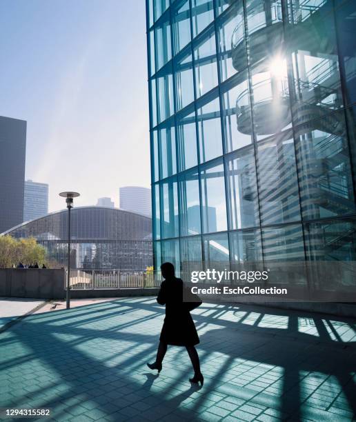 businesswoman walking towards center of business district - la defense bildbanksfoton och bilder