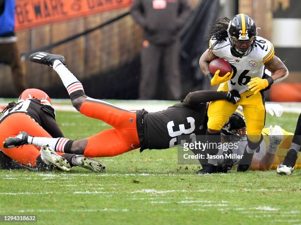 Anthony McFarland of the Pittsburgh Steelers is tackled by Ronnie Harrison of the Cleveland Browns in the second quarter at FirstEnergy Stadium on...