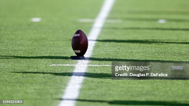 General view of a football on a stand with shadows of the Auburn Tigers players approaching for a kickoff during the second quarter against the...