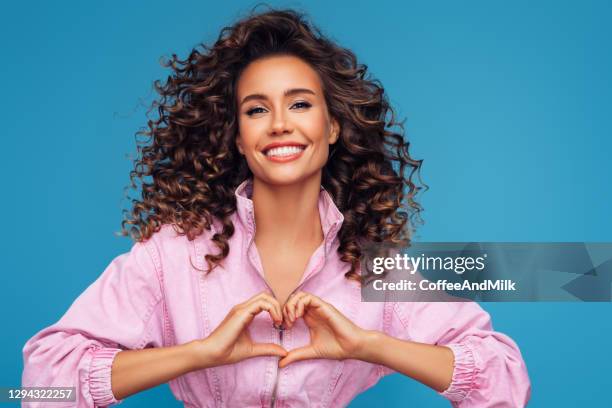 beautiful girl on a blue background - vintage hairstyle stock pictures, royalty-free photos & images