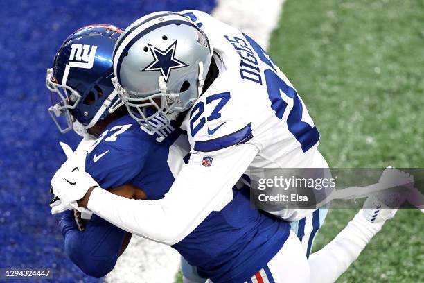 Sterling Shepard of the New York Giants scores a touchdown as he is wrapped up by Trevon Diggs of the Dallas Cowboys during the second quarter at...