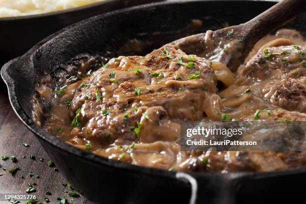 salisbury steak in a rich mushroom and onion gravy with mashed potatoes - gravy stock pictures, royalty-free photos & images