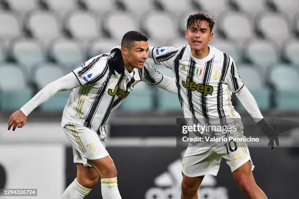Cristiano Ronaldo of Juventus F.C. Celebrates with teammate Paulo Dybala after scoring their team's first goal during the Serie A match between...