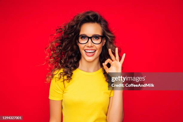 attractive smiling young woman - ok sign stock pictures, royalty-free photos & images