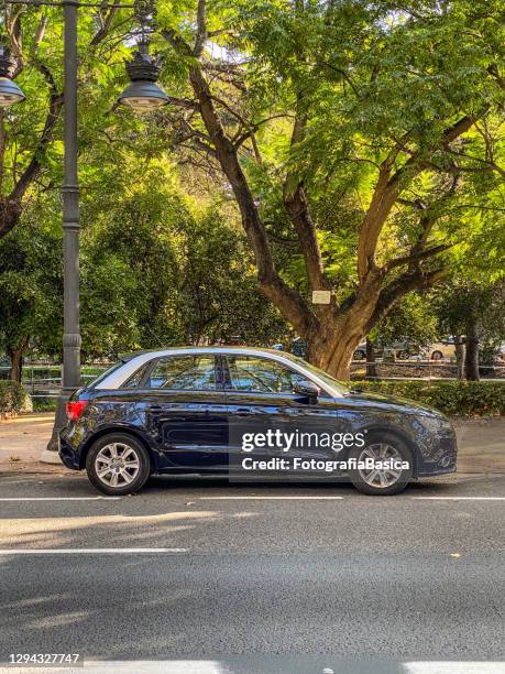 blue audi car model a1 parked in the street - saloon car stock pictures, royalty-free photos & images