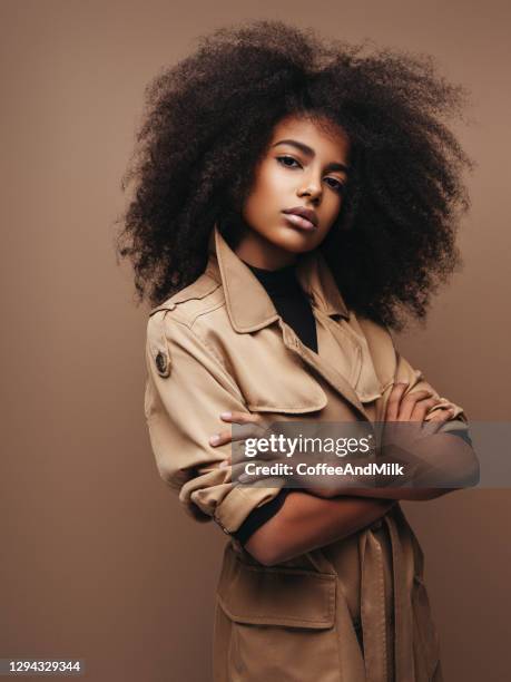 photo of cheerful curly woman - beautiful african girls stock pictures, royalty-free photos & images