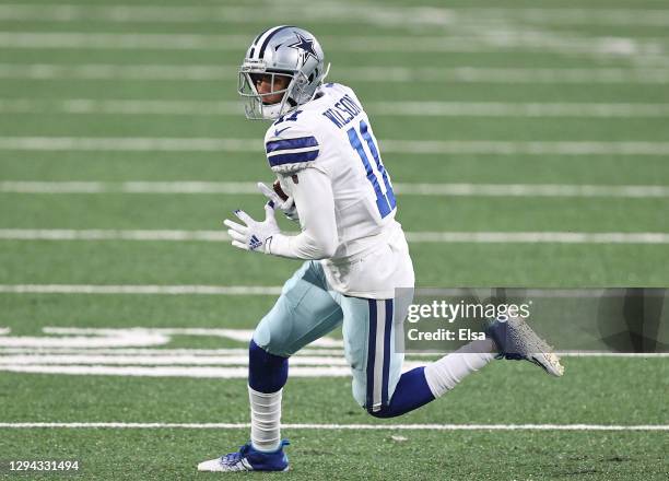 Cedrick Wilson of the Dallas Cowboys carries the ball against the New York Giants during the fourth quarter at MetLife Stadium on January 03, 2021 in...