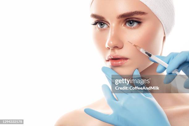 woman having facial injections - woman injecting stock pictures, royalty-free photos & images
