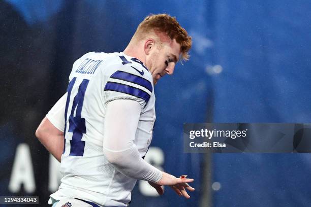 Andy Dalton of the Dallas Cowboys checks his injured hand as he walks off the field following his teams 23-19 defeat against the New York Giants at...