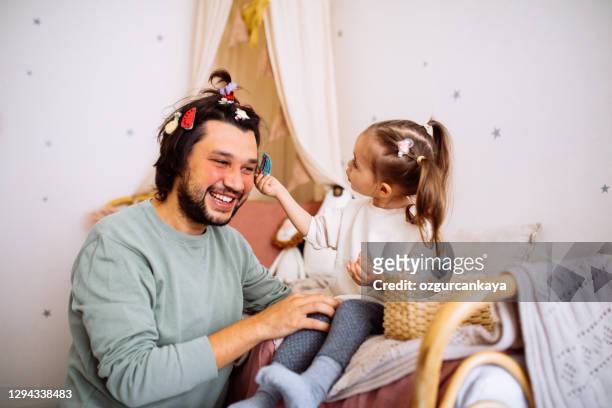 dad with daughter hav fun at home - man combing hair stock pictures, royalty-free photos & images