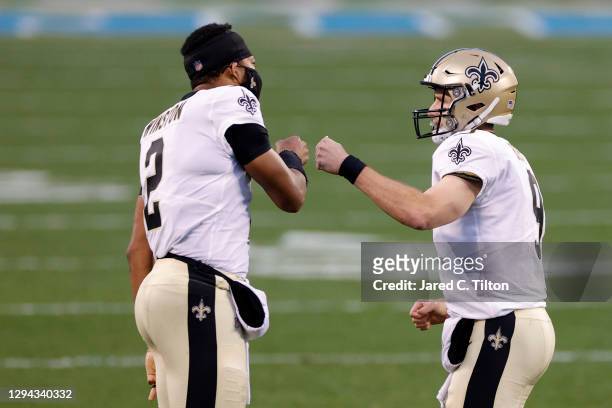 Quarterback Drew Brees of the New Orleans Saints celebrates with teammate quarterback Jameis Winston following a touchdown pass during the first...