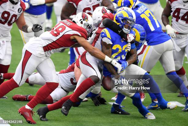 Cam Akers of the Los Angeles Rams fumbles the ball at the goal line as he is tackled by De'Vondre Campbell and Isaiah Simmons of the Arizona...