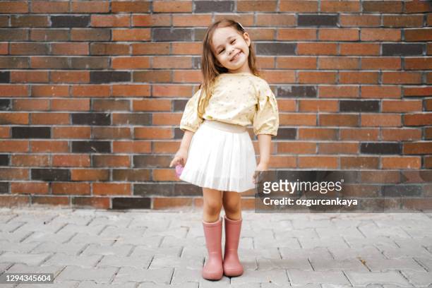 cute little girl having fun time in the nature - girl wearing boots stock pictures, royalty-free photos & images