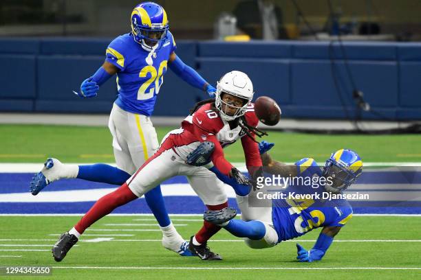 DeAndre Hopkins of the Arizona Cardinals makes a reception as he is defended by Jalen Ramsey and John Johnson III of the Los Angeles Rams during the...