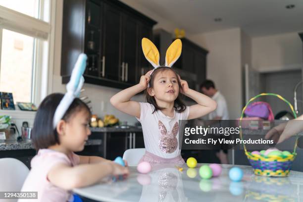 sisters decorating easter eggs - family rabbit stock pictures, royalty-free photos & images