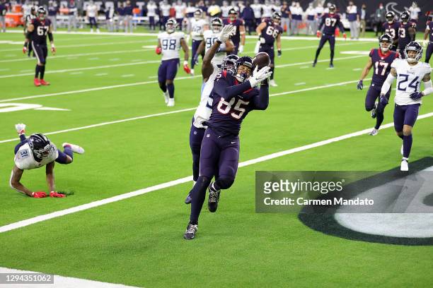 Pharaoh Brown of the Houston Texans catches a pass for a touchdown over David Long of the Tennessee Titans during the second half of a game at NRG...