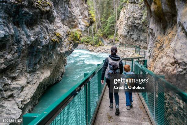 mother and son hiking at johnson canyon in banff national park, canada - banff canada stock pictures, royalty-free photos & images