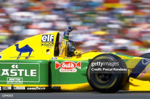 Michael Schumacher of Germany driving the Camel Benetton Ford Benetton B193B Ford HB V8 raises a clenched fist to the crowd after finishing in second...