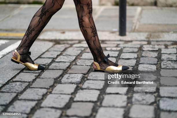 Alba Garavito Torre wears mesh floral print tights, golden flat ballerina Chanel pointy shoes with black tips, on December 22, 2020 in Paris, France.
