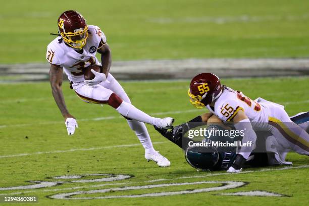 Strong safety Kamren Curl of the Washington Football Team is tackled by tight end Dallas Goedert of the Philadelphia Eagles after an interception...