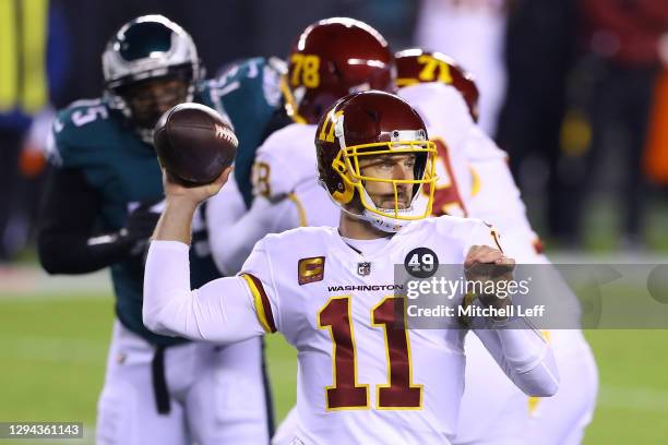 Quarterback Alex Smith of the Washington Football Team drops back to pass over the defense of the Philadelphia Eagles during the first quarter of the...