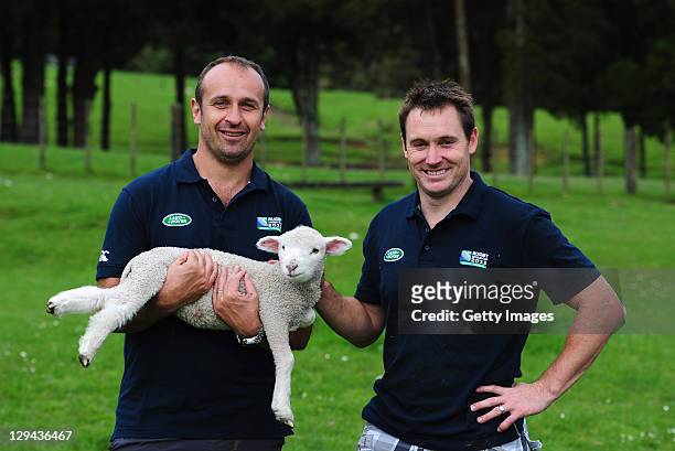 Former French rugby player Philippe Saint Andre and former All Black Andrew Mehrtens pose for photographs with a lamb after the sheep herding...
